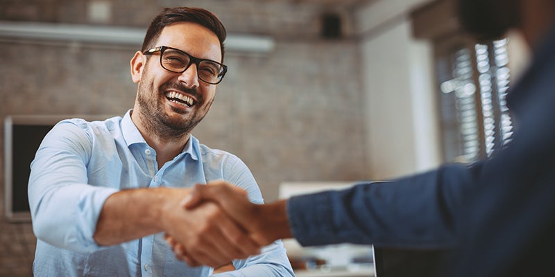 customer shaking hand with sales rep at Alexandria Chevrolet Cadillac in Alexandria MN 
