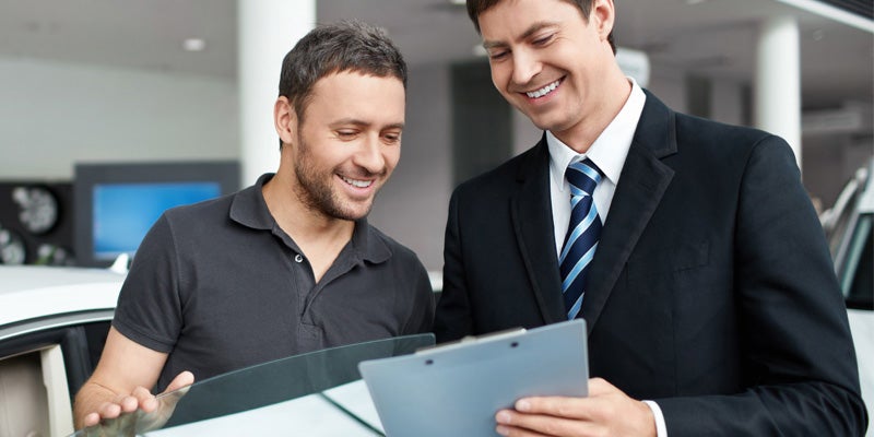 customer going over paperwork with sales rep at Alexandria Chevrolet Cadillac in Alexandria MN 