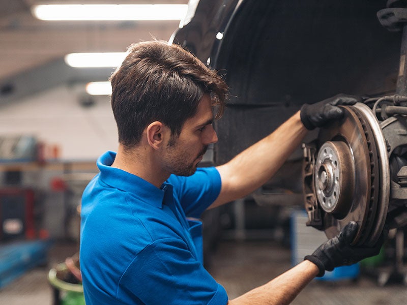 service technician changing brakes at Alexandria Chevrolet Cadillac in Alexandria MN 